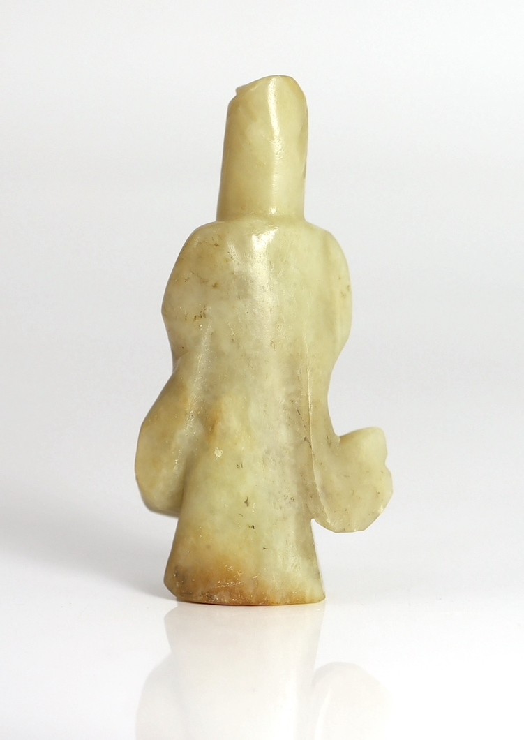 An early Chinese cream jade figure of Guanyin, together with a 19th century pale celadon and brown jade brushrest